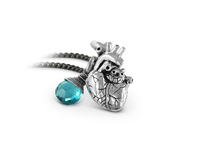 Small Anatomical Heart Necklace with Blue Topaz in Silver - shown on gunmetal chain