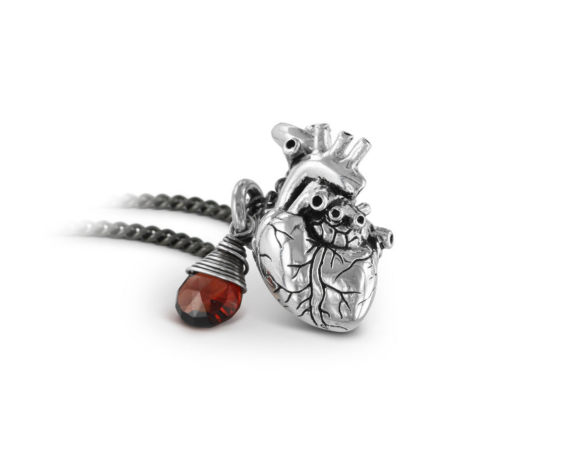 Small Anatomical Heart Necklace with Garnet in Silver - shown on gunmetal chain