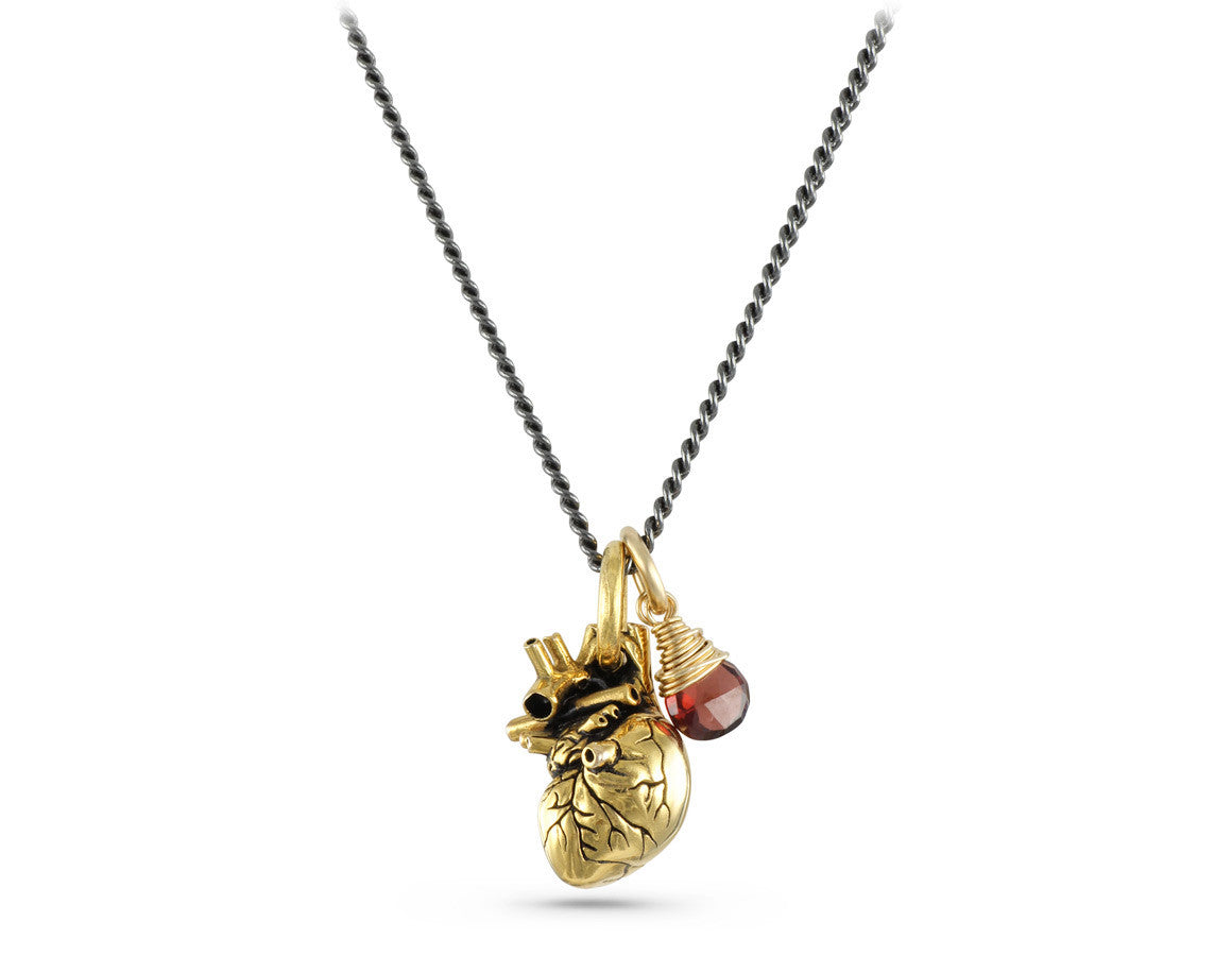 Small Anatomical Heart Necklace with Garnet in Gold - shown on gunmetal chain