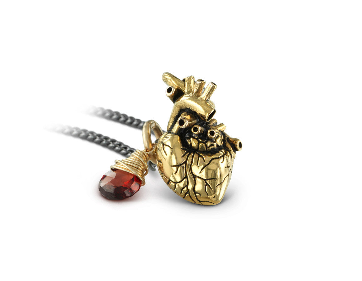 Small Anatomical Heart Necklace with Garnet in Gold - shown on gunmetal chain