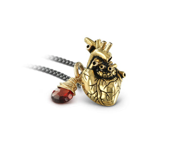 Small Anatomical Heart Necklace with Garnet in Gold - shown on gunmetal chain